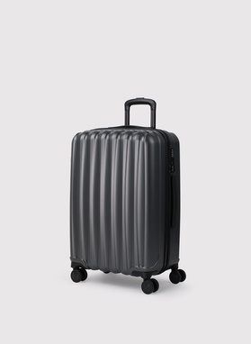 Vidutinis tamsiai pilkas lagaminas su grioveliais